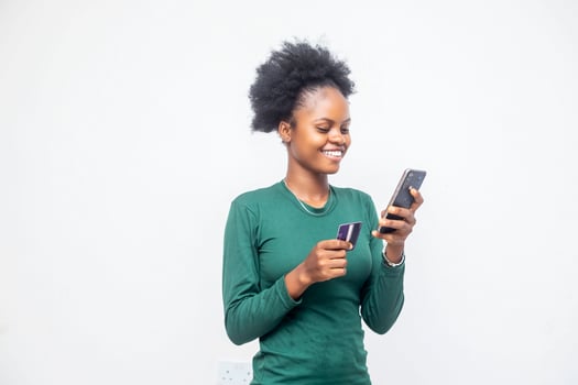 beautiful African lady using her phone and card photo
