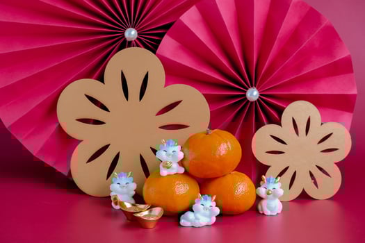 Chinese New Year of the dragon festival concept. Mandarin orange, red envelopes, dragon and gold ingot with red paper fans. Traditional holiday lunar New Year. photo