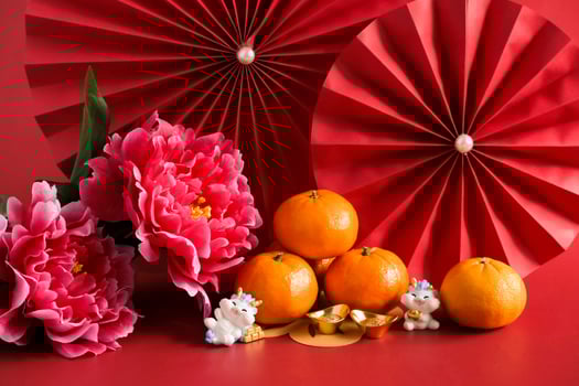 Chinese New Year of the dragon festival concept. Mandarin orange, red envelopes, dragon and gold ingot with red paper fans. Traditional holiday lunar New Year. photo
