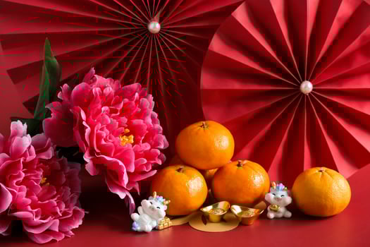 Chinese New Year of the dragon festival concept. Mandarin orange, red envelopes, dragon and gold ingot with red paper fans. Traditional holiday lunar New Year. photo