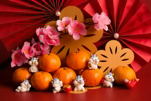 Chinese New Year of the dragon festival concept. Mandarin orange, red envelopes, dragon and gold ingot with red paper fans. Traditional holiday lunar New Year. photo