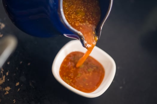 Pour sukiyaki sauce with sesame seeds from jar photo