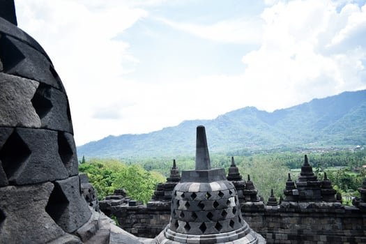 The beauty of Borobudur temple, with a backdrop of green forests and blue skies photo