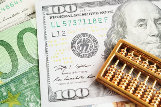 Gold abacus on banknote money, finance trading investment business currency concept. photo