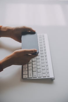 Asian Businesswoman Using laptop computer and working at office with calculator document on desk, doing planning analyzing the financial report, business plan investment, finance analysis concept. photo