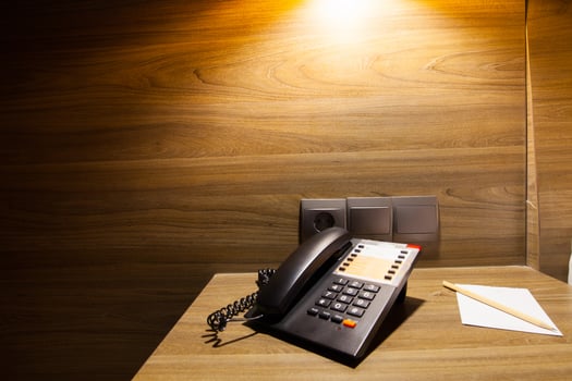 telephone on wooden table under light photo
