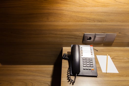 telephone on wooden table under light photo