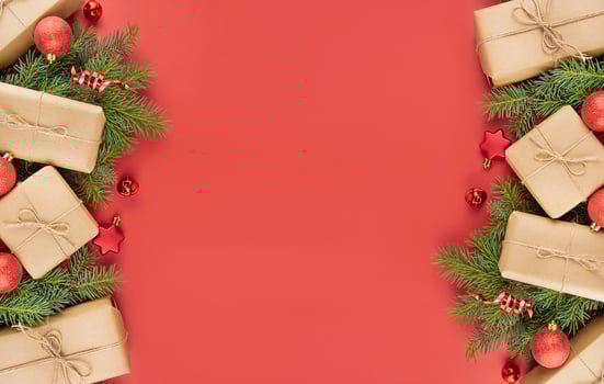 Christmas frame made of gift boxes, red balls, serpentine on a red background. Festive Christmas decorations. Christmas background. Banner layout, postcard. The apartment was lying. Copy space photo