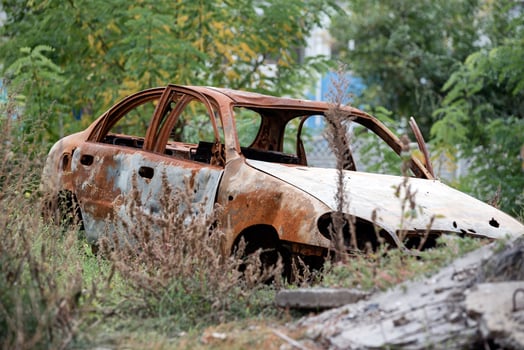 burned out blown up car against the background of a destroyed house war between Russia and Ukraine photo