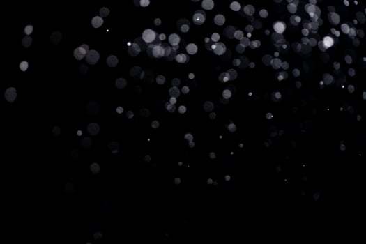 small drops of rain, snow on a black background. wind. Natural background photo