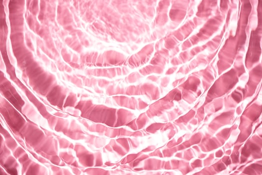 Beautiful water texture with waves. pink color, water background photo