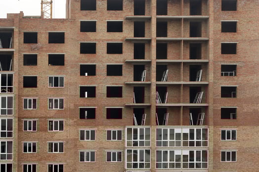 View of a large construction site with buildings under construction and multi-storey residential homes. Housing renovation photo
