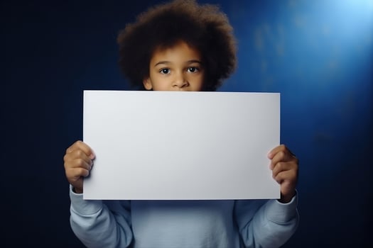 AI generated Little boy holding a blank white sheet of paper photo