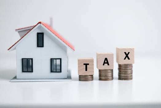Concept of paying state property tax. Property Tax Wooden Blocks With A Miniature House. house model, mortgage loading real estate property with loan money bank concept.Home sales and home insurance photo