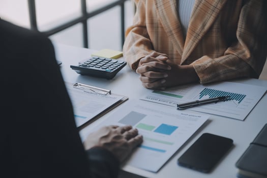 Financial analysts analyze business financial reports on a digital tablet planning investment project during a discussion at a meeting of corporate showing the results of their successful teamwork. photo