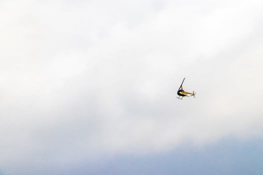 Tourist helicopter flies over the Caribbean Sea in Mexico. photo