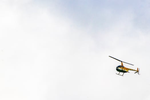 Tourist helicopter flies over the Caribbean Sea in Mexico. photo