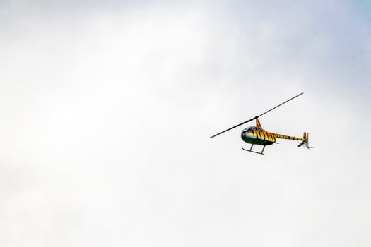 Tourist helicopter flies over the Caribbean Sea in Mexico. photo
