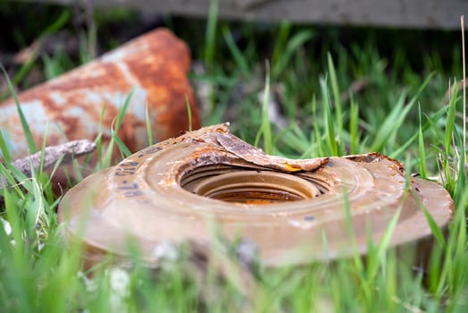 military weapon mine in green grass on a city street in Ukraine photo
