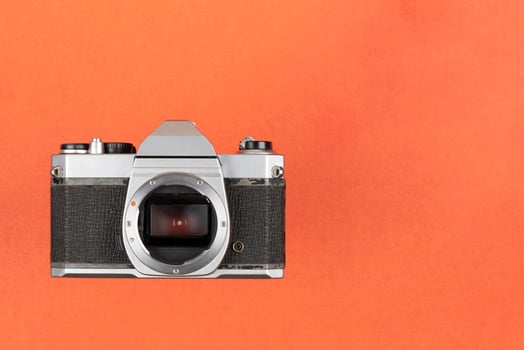 Vintage Film Camera isolated on red background photo