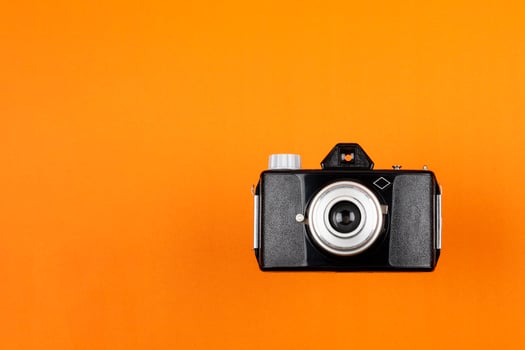 Vintage Film Camera isolated on red background photo