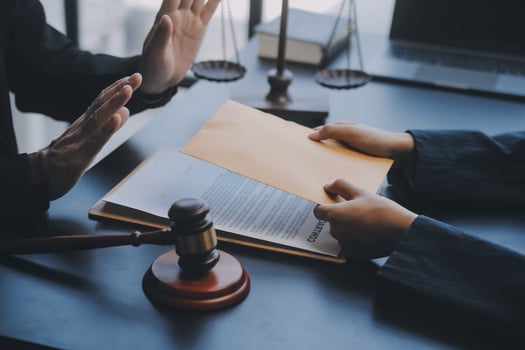 Business and lawyers discussing contract papers with brass scale on desk in office. Law, legal services, advice, justice and law concept picture with film grain effect photo