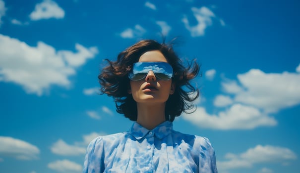 AI generated Portrait of a young beautiful woman in sunglasses against the blue sky photo