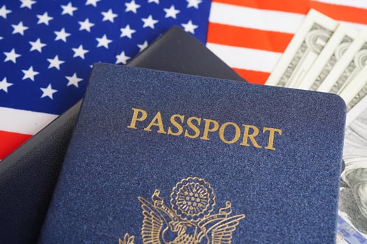 US passport with dollar money on USA flag, American citizen in United States of America. photo