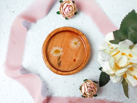 flat lay composition of resin and wood coaster on grey background photo