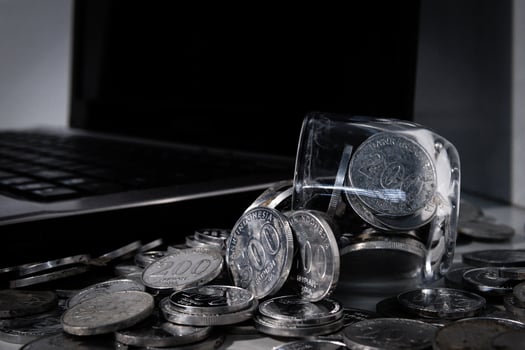 Coin Indonesian rupiah and laptop photo