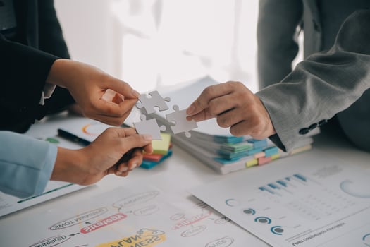 Cropped shot of Businesswoman hand connecting jigsaw puzzle with sunlight effect, Business solutions, success, and Assembling jigsaw pieces, strategy ideas. photo