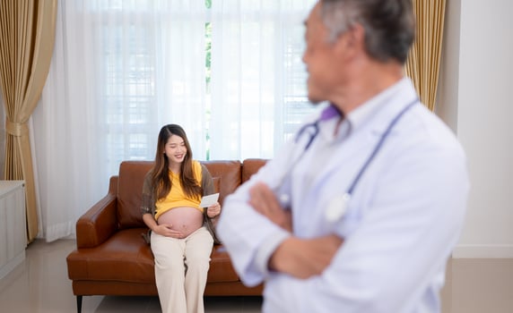 Portrait of obstetrician gynecologist, Asian pregnant woman visit gynecologist doctor at medical clinic for pregnancy consultant. photo