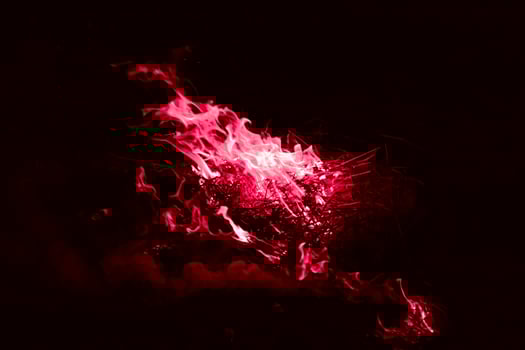 A dark red flame. Burning of rice straw at night. photo