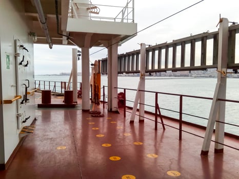 The deck of a cargo ship. Red floor and white walls. photo