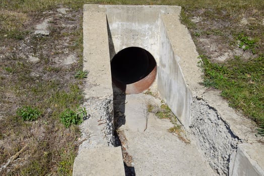 Tunnel for draining rainwater under the road. View through the pipe photo