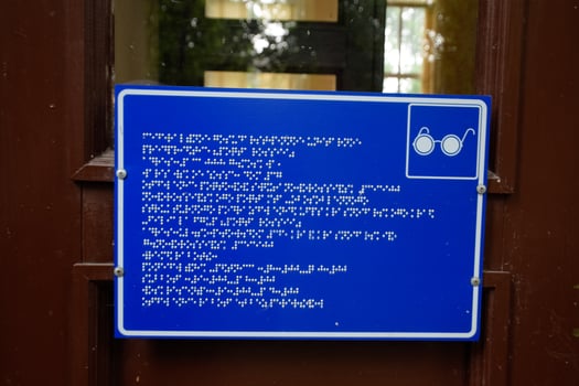 plate with a tongue for the blind on the doors of the building. photo