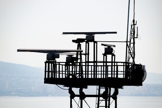 Rotating antennas of a military radio station on tower. photo