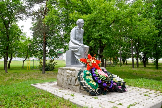 Monument to the Mother of a Soldier waiting for her son from the war. Sculpture of an unknown author in the park of the village of Pervomaisky, Krasnodar Krai, Russia. photo