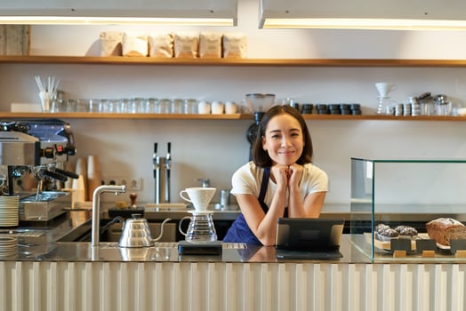 Small business owners. Smiling asian girl barista, standing at counter with filter coffee brewing kit and POS terminal, cafe and people concept photo