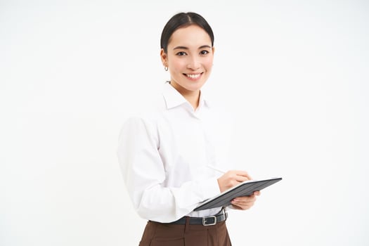 Corporate and young entrepreneurs concept. Successful businesswoman using digital tablet, prepares for meeting, looks at business concept on her gadget photo