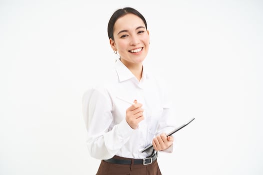 Beautiful asian woman, entrepreneur with digital tablet, working on business project, leading meeting and looking at notes on device, white background photo