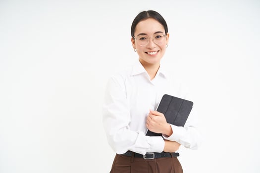 Beautiful asian woman, entrepreneur with digital tablet, working on business project, leading meeting and looking at notes on device, white background photo