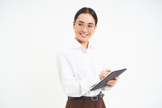 Asian woman professional, businesswoman in glasses, holding digital tablet, standing confident against white background photo