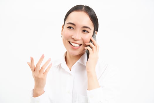 Portrait of asian corporate woman, businesswoman talks on mobile phone, has conversation over cellphone, speaking on telephone, white background photo