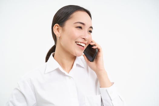 Portrait of asian corporate woman, businesswoman talks on mobile phone, has conversation over cellphone, speaking on telephone, white background photo