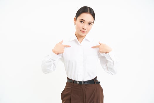 Business and corporate concept. Confident asian woman, saleswoman points at herself with serious face, white background photo