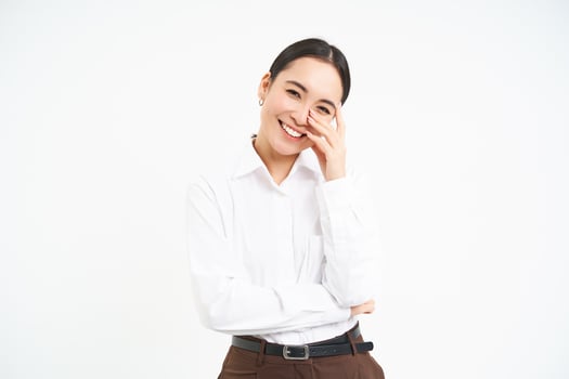 Wellbeing and workplace. Smiling happy asian saleswoman, office manager laughing and looking joyful, isolated over white background photo