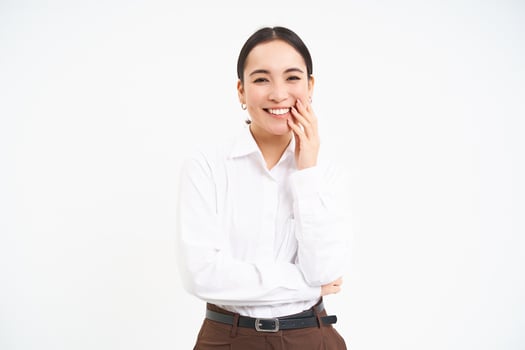 Portrait of smiling korean woman, businesswoman with carefree happiness on her face, white studio background photo