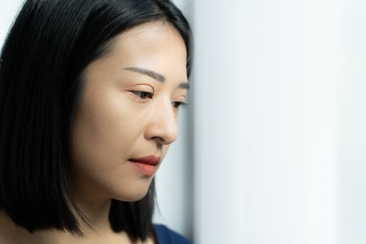 Depression and mental illness. Asian woman disappointed, sad after receiving bad news. Stressed girl confused with unhappy problems, arguing with boyfriend, cry and worry about unexpected pregnancy. photo