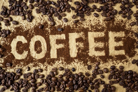 Roasted coffee beans on brown wrapping paper. photo
